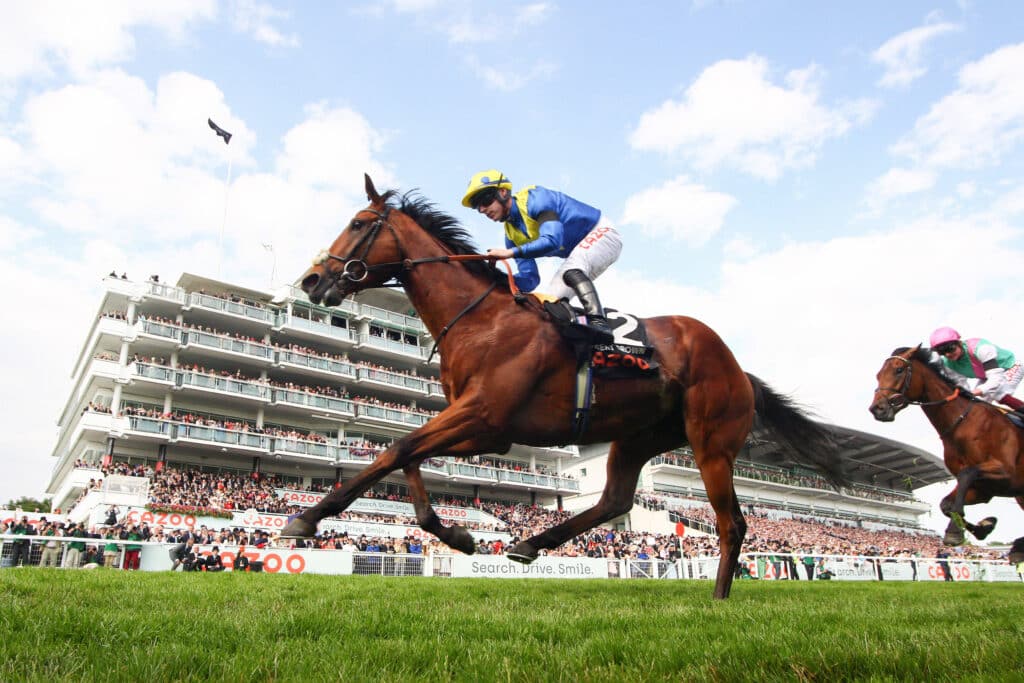 Epsom Derby Day Desert Crown ridden by Richard Kingscote (Blue, Yellow Chevron) wins the Cazoo Derby (In Memory Of Lest